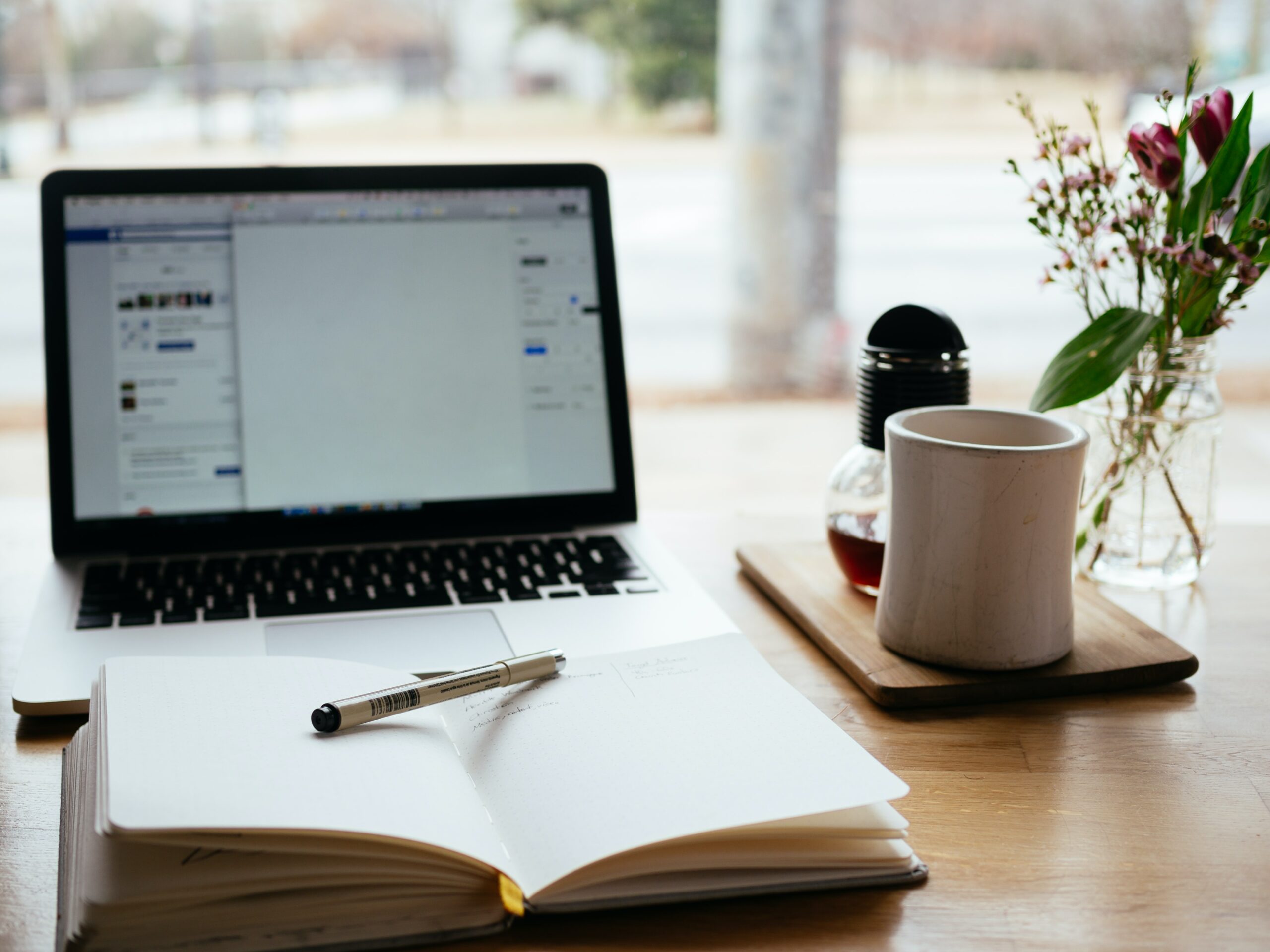 Laptop and notepad. Photo by Nick Morrison at Unsplash.