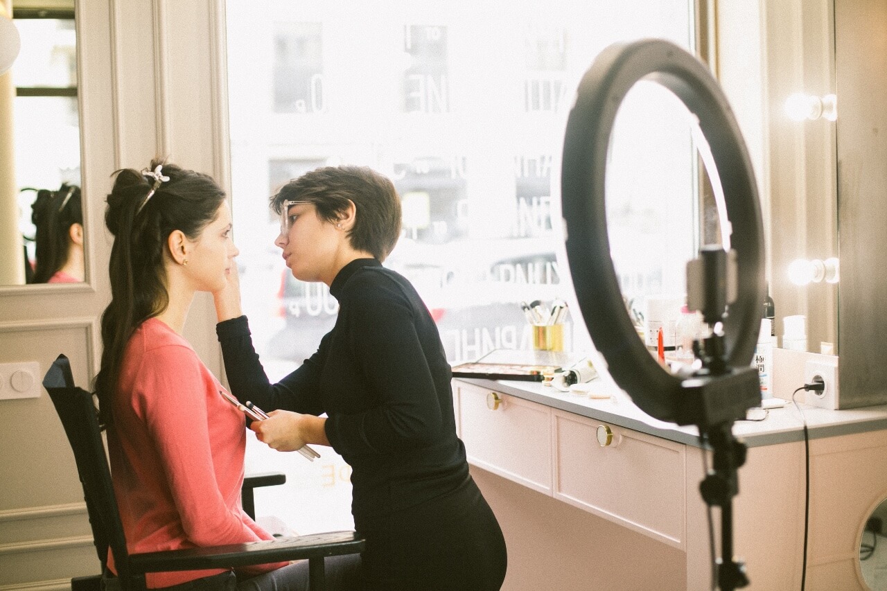 Professional makeup artist applying makeup to client